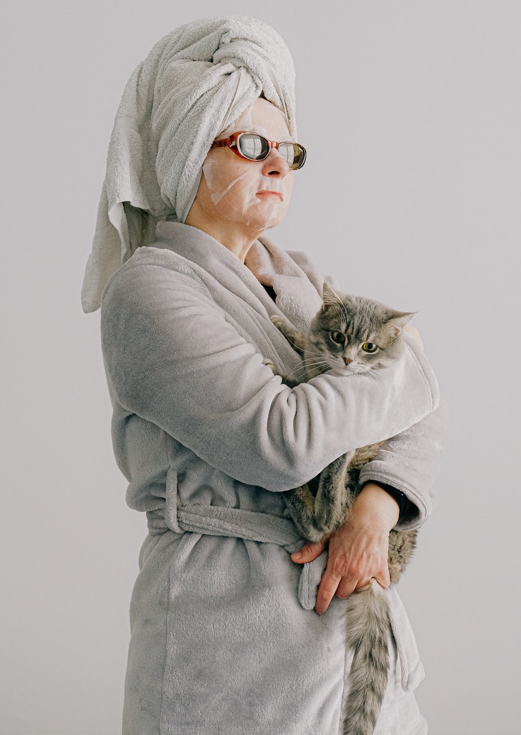 Woman holding a cat after completing her anti-aging skin routine